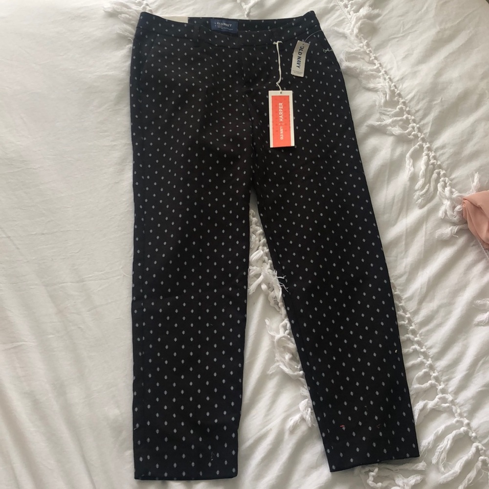 Black pants with white designs on them